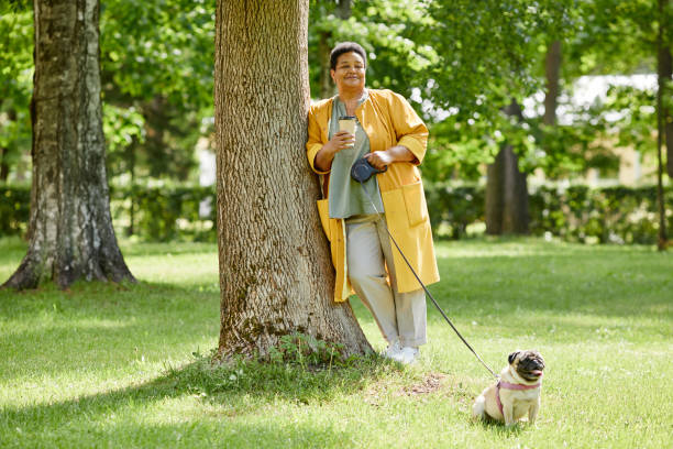 istock Woman with Dog in Park 1415356453
