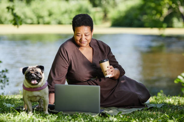 istock Woman with Dog by Lake 1415356455