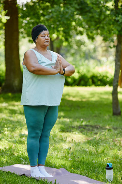istock Black Woman doing Yoga in Park 1415356462