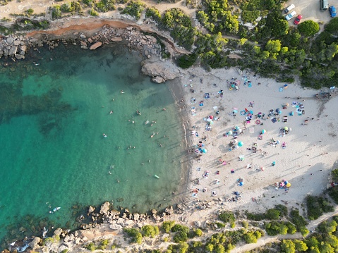 aerial view of a paradisiacal beach with people enjoying the sea