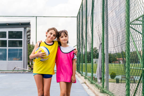 istock Two volleyball teammates walking off the field after a win 1415357369
