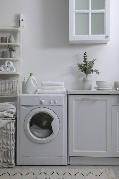 istock Kitchen interior with washing machine and stylish furniture 1415357495