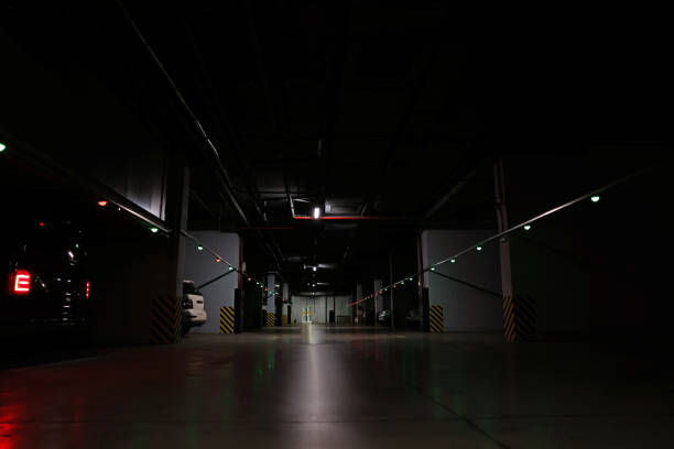 Modern parking garage with cars at night