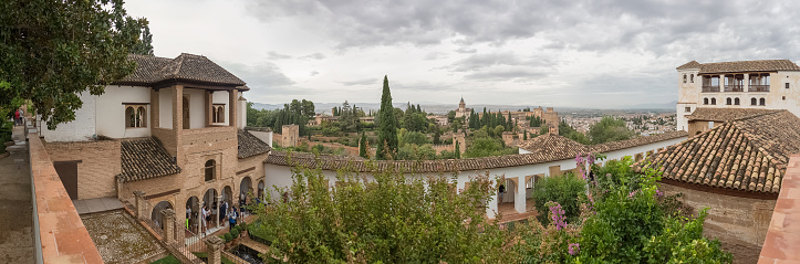 Alhambra Granada Spain - 09 14 2021: Panoramic view at the Garden Water Channel, or Patio de la Acequia, Generalife Gardens, Alhambra citadel as background, Granada, Spain