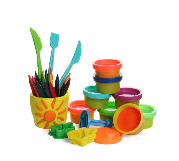 istock Set of bright play dough with tools and colorful pencils on white background 1415359535