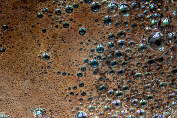 istock Coffee foam, screensaver from bubbles in coffee 1415359701