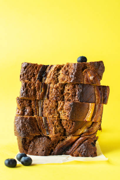 istock Sliced banana bread with blueberries on yellow background. 1415361845