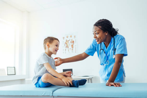 istock Young Boy is Examined by Female Doctor 1415363879