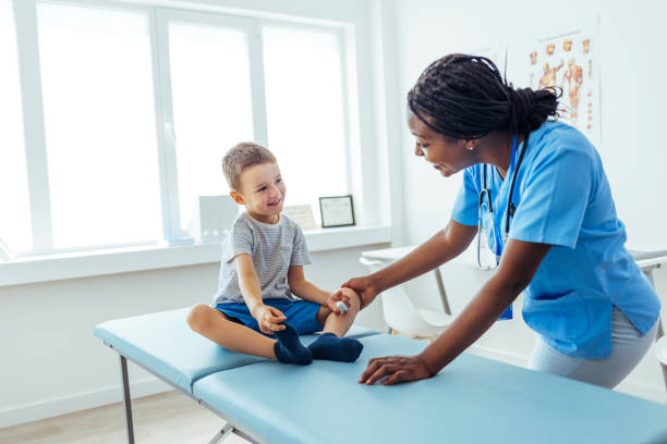 istock Pediatrician smiles as young patient speaks 1415363931