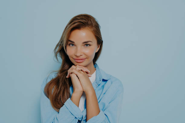 istock Confident woman with intrigued face expression on light blue background 1415364085