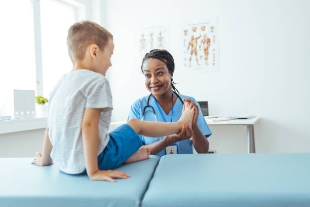 doctor is checking his muscles and bones - doctors office examination room examination table office imagens e fotografias de stock