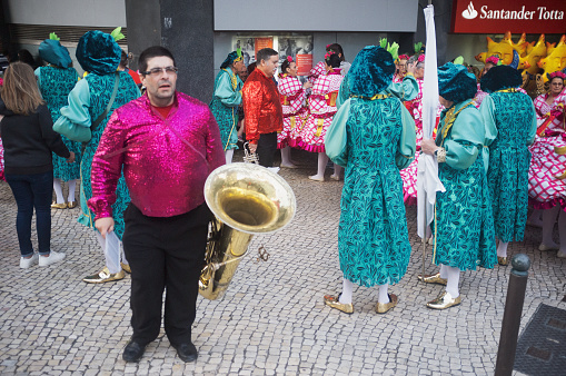 Lisbon, Portugal - June 12, 2018: Men, women and band musicians dressed in traditional folklore costumes, prepare to parade in Lisbon downtown during this city celebrations of the Popular Saints.