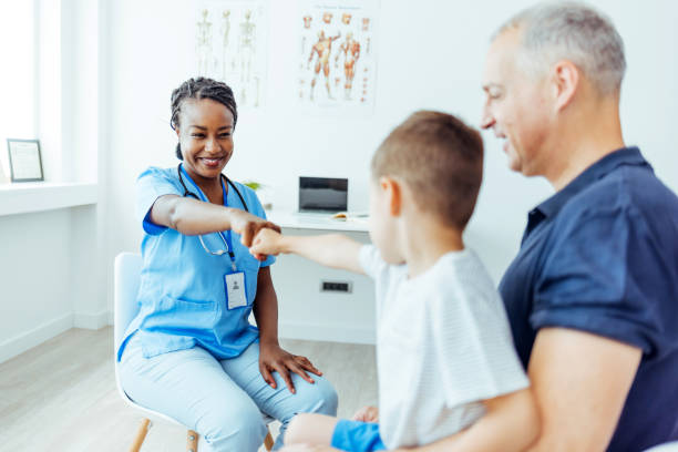 istock Doctor Fist Bump with Little Boy 1415365932