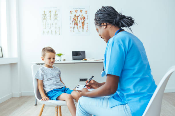 istock Young doctor holding clipboard while looking at patient 1415366025