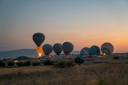 Albuquerque, New Mexico - USA - Oct 7, 2023: Gas balloons preparing to launch after sunset for the 66th Coupe Aeronautique Gordon Bennett balloon race at the Albuquerque International Balloon Fiesta.