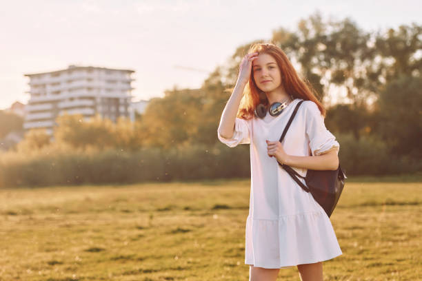 istock Having a walk. Young girl is on the field at sunny daytime having nice weekend 1415373621