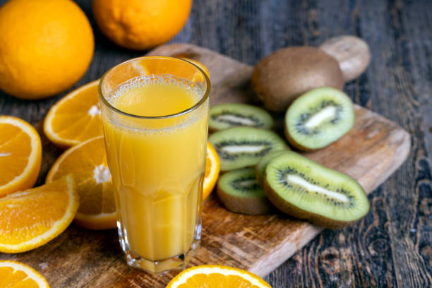 uncut orange on a wooden chopping board, cooking and desserts from ripe citrus orange