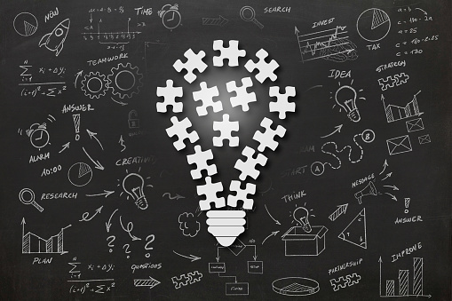 Idea puzzle light bulb teamwork brainstorming solution