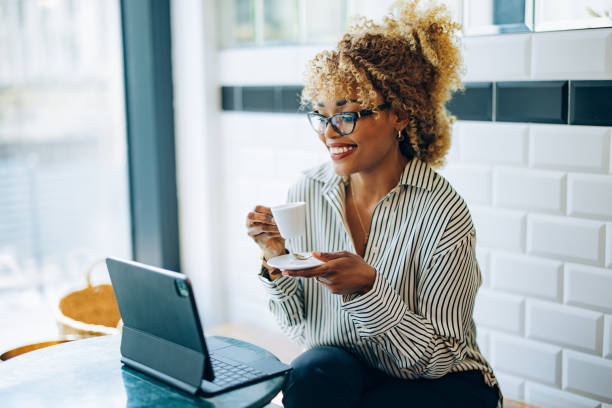 istock Beautiful Female Entrepreneur Working from the Cafe 1415377817