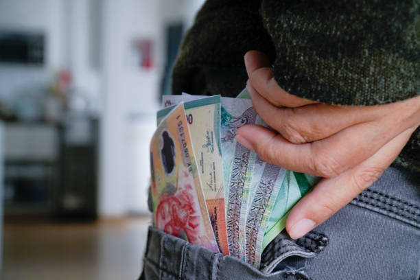 istock Banknotes in pants pocket, close-up spending money. 1415380493