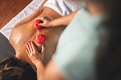 Young woman enjoying at spa during back massage in a luxury spa