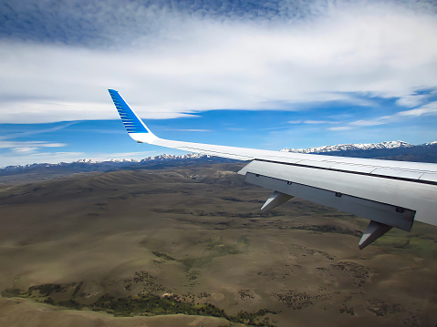 Aerolíneas Argentinas Airplane wing. Airplane flying over Patagonia region
