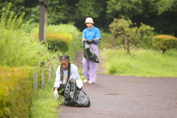 istock Black female engaging in community clean up 1415382341