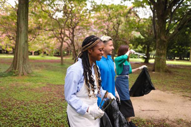 istock Volunteers of diverse backgrounds chatting in park 1415382371