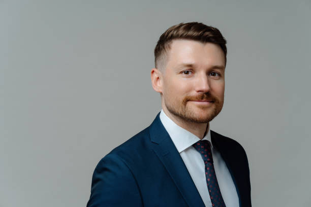 istock Confident happy executive manager looking at camera and smiling while posing against grey background 1415386472