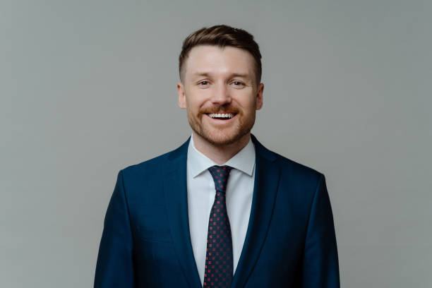 istock Happy professional businessman in suit smiling at camera 1415386485