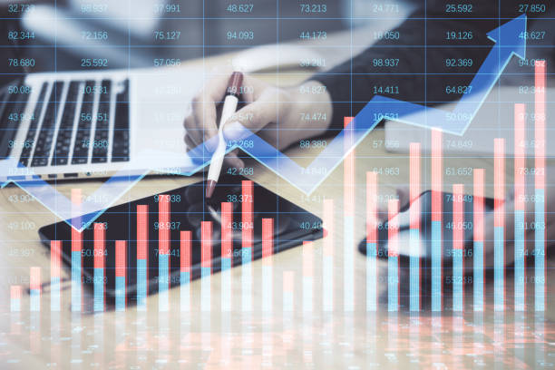 istock Close up of man hands using digital tablet with pen and other devices with creative growing financial forex chart with upward arrow on blurry background. Market, stock and trading concept. Double exposure. 1415386735