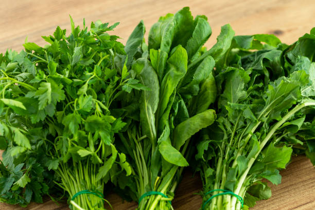 Vegetarian diet or green nutrition concept. Close up photo of bunch of water cress or garden cress, parsley and arugula. Vegetarian diet or green nutrition concept. watercress stock pictures, royalty-free photos & images