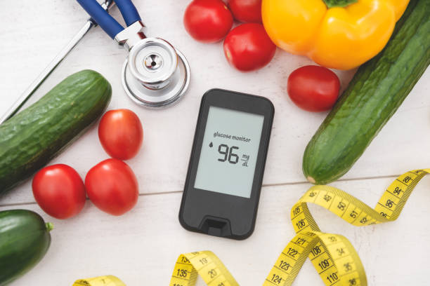 istock Glucometer with fresh vegetables. Diabetes concept 1415387532