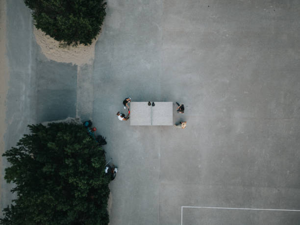 istock Group of friends playing table tennis after work. 1415387684
