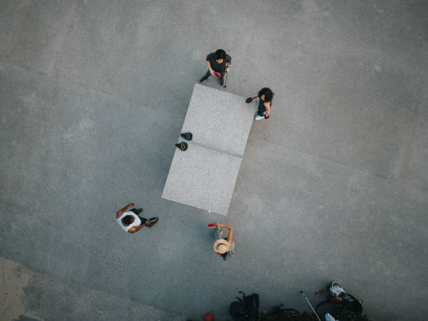 Drone view of group of friends playing tabletennis outdoors.