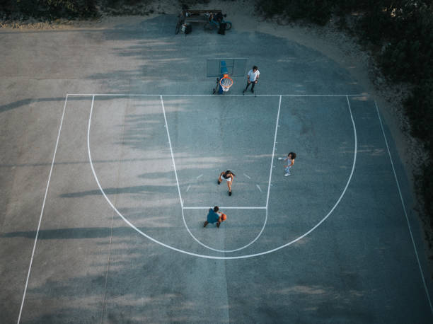 High angle view of friends playing basketball outdoors.
