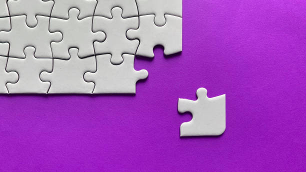 istock Jigsaw puzzle on purple background with customizable space for text or ideas. Copy space 1415388409