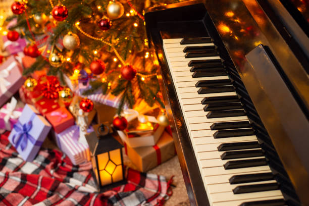 istock Top view of piano and Christmas tree with present boxes under it 1415389803