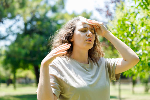 istock Young woman having hot flash and sweating in a warm summer day 1415391490