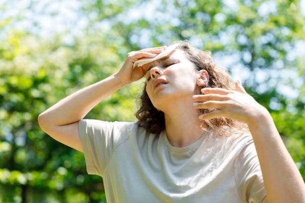 istock Young woman having hot flash and sweating in a warm summer day 1415391491