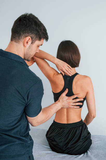 istock Working with spine and neck. Woman visiting physiologist that making massages and helping with traumas 1415392493
