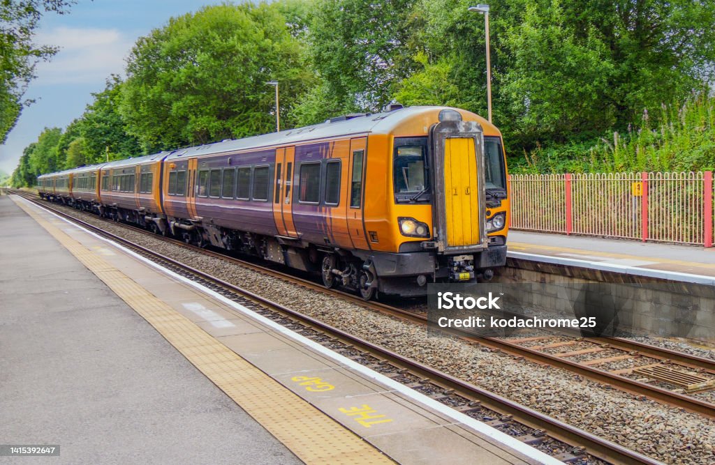Generic Diesel powered railway line station in the English countryside. A station England UK. Diesel powered railway line in the English countryside. Station on a sunny day. Rail Transportation Stock Photo