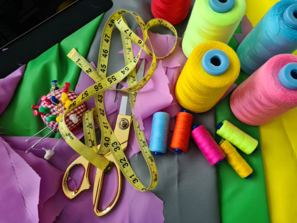 istock Sewing products and seamstress tools. Scissors tape measure thread and pins 1415392819