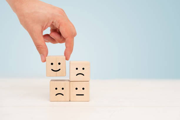 istock Wooden cube block, smile and sad emotions concept 1415394139