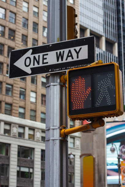 istock One Way Sign and Red Light on Pole 1415395027