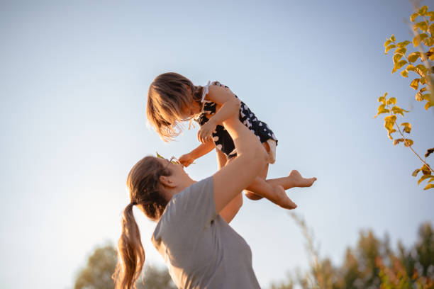 istock mother holding her daughter in her arms 1415395376