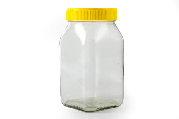 istock Empty transparent glass jar with yellow cap 1415396141