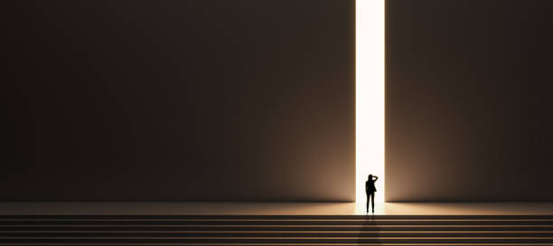 Wide image with mock up place for your advertisement. Back view of backlit businesswoman walking on stairs towards bright opening in dark wall. Success, way out, exit and solution concept. stock photo
