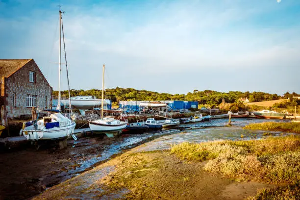 Low tide at Yarmouth marina boat yard on the Isle of Wight with the yachts resting on the floor at low tide