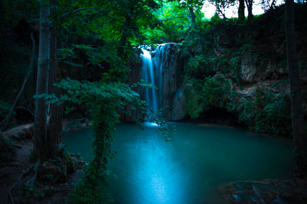 istock waterfall in forest in nature with motion blur in night 1415396876